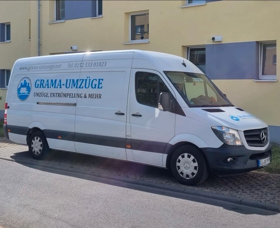 Transporter von GRAMA-UMZÜGE vor einem Wohnhaus